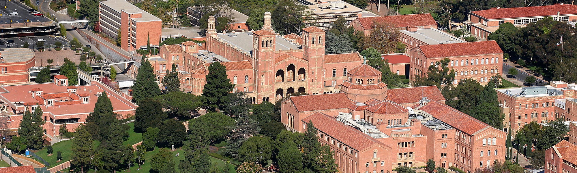 UCLA campus aerial view with red-brick buildings and surrounding greenery.