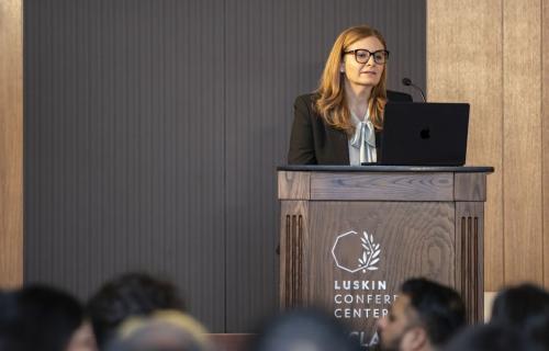 Lucy Avetisyan giving a speech and the Luskin Conference Center.