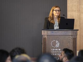 Lucy Avetisyan giving a speech and the Luskin Conference Center.